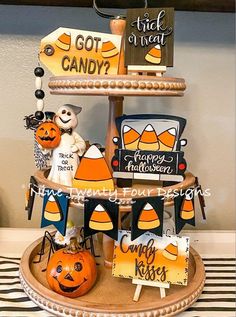 a three tiered tray with halloween themed items on it, including pumpkins and jack - o'- lanterns