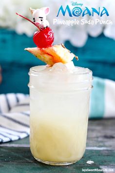 there is a drink with a cherry on top in a mason jar that has pineapple soda punch in it