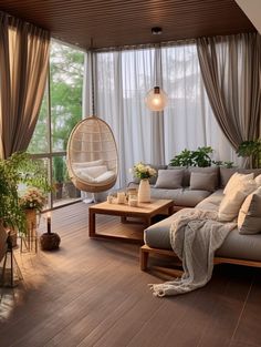 a living room filled with lots of furniture and plants on top of wooden flooring