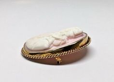 Large 10k Yellow Gold Oval Pink Conch Shell High Relief Cameo Brooch Pin Pendant Metal: 10K yellow gold (acid tested) Weight: 33.6 grams Size: 55mm long x 45mm wide (including frame), Sits 11mm off surface (at highest point) Hallmarked: Symbol of a rose Hidden swivel fold down bail enables the brooch to be worn as a pendant or a pin Pin and closure work perfectly This is an estate piece in very good condition, it is in it's original worn state and can be re-polished upon request. Please see pict Carved Oval Brooch For Formal Occasions, Carved Oval Brooch For Formal Wear, Carved Oval Brooches For Formal Wear, White Oval Cameo Brooches, Carved Oval Brooch As Gift, Carved Oval Brooch For Gift, Carved Oval Brooches As Gift, Oval Cabochon Brooches For Anniversary, Oval Intaglio Brooches As A Gift