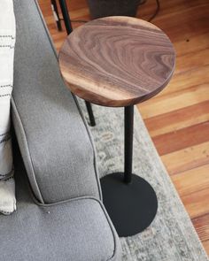 a grey couch with a wooden table on top of it next to a gray chair