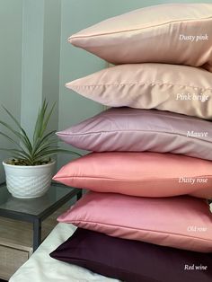 four pillows stacked on top of each other with the names of different colors and sizes