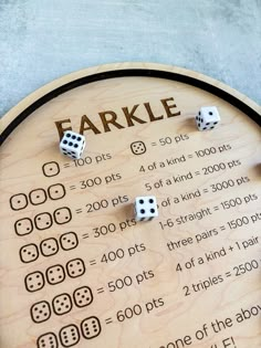 a wooden board with dices on it and the word farkle written in large letters