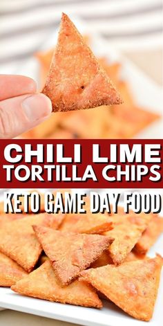 a hand holding a tortilla chip over a white plate with keto game day food