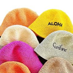 six hats with the word aloh written on one side and four different colors in the other