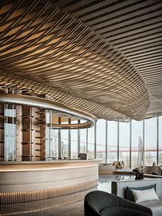 a living room filled with furniture next to large window covered in wooden slatted coverings