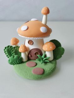 a small mushroom house on top of a lush green field