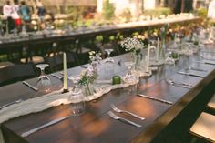 the long table is set with flowers and candles