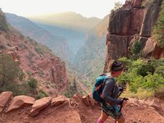 a woman hiking up the side of a mountain