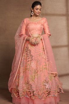 This stunning Peach Embroidered Lehenga Set is a quintessential choice for any event. The set consists of Italian silk blouse with elbow sleeves, thread & sequins embroidery detailing, round neck teamed with flared organza lehenga with digital print & sequins embroidery detailing and a net dupatta. LehengaFabric – Organza + NetFlair – 4 Mtr (First Layer – Net & Work Part) & 4.5 Mtr (Second Layer –Digital Print) & 11.5 Mtr (Third Layer–Net)Work – Digital Print & Sequins Embroidery WorkSize - Free Size Up to 44 Inches (Waist)Stitch Type - Semi-Stitched (Standard Cancan & Canvas Attached) BlouseFabric - Italian SilkWork - Thread & Sequins Embroidery Work Size - 1 Meter (Bust Size Up to 46 Inches)Stitch Type - Unstitched DupattaFabric - NetWork - Thread & Sequins Embroidery WorkSize – 2.30 Met Peach Lehenga, Pakistani Lehenga, Silk Sarees Online Shopping, Sequence Embroidery, Indian Lehenga Choli, Reception Lehenga, Floral Lehenga, Organza Lehenga, Lehenga Gown