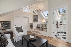 a living room filled with white furniture and lots of windows