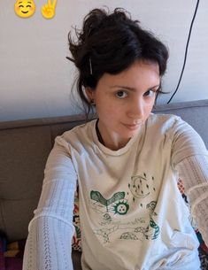 a woman sitting at a table with food in front of her and two smiley faces above her