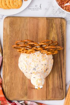 pretzels and cheese on a wooden cutting board