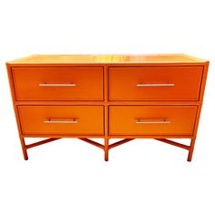 an orange dresser with four drawers on it