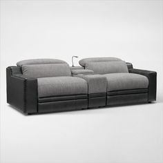 a grey couch with two recliners on it's back and armrests