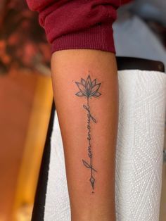 a woman's arm with a tattoo on it that says i love you and has a flower