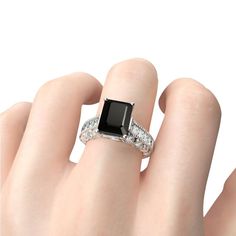 a woman's hand with a black and white diamond ring