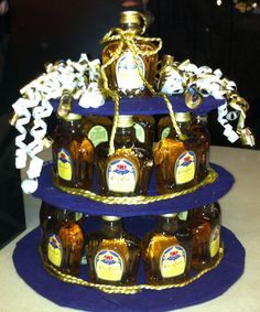 there is a three tiered cake made to look like honey bottles