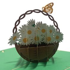 a basket with daisies and a butterfly on it