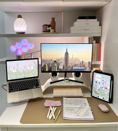 two computer monitors sitting on top of a desk next to a keyboard and mouse in front of a monitor