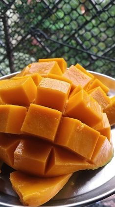 a metal plate topped with cut up pieces of mango