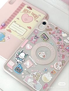 an iphone case with hello kitty stickers on the front and back cover is shown