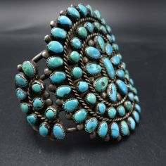 "OLD NAVAJO BRACELET DESCRIPTION: This exquisite cuff features round and oval cabs of old natural turquoise set in micro serrated bezel. This fabulous vintage bracelet will be a cherished addition to your collection of fine vintage Native American jewelry. MEASUREMENTS: Interior of the cuff measures 5\" with an additional 1\" slightly adjustable gap. Total circumference: 6\" Measures 2 1/8\" straight across the widest part (from wrist bone to wrist bone) Bracelet face measures 2 1/2\" wide (the Oval Turquoise Collectible Bracelet, Vintage Gemstone Cuff Bracelet Bangle, Vintage Gemstone Cuff Bracelet, Antique Turquoise Bangle, Vintage Cabochon Bangle Bracelets, Vintage Cabochon Bangle Bracelet, Vintage Adjustable Gemstone Cuff Bracelet, Vintage Cabochon Bangle Jewelry, Adjustable Vintage Gemstone Cuff Bracelet