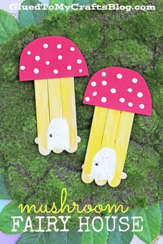 two popsicle mushrooms with white polka dots on them are sitting in the grass next to green leaves