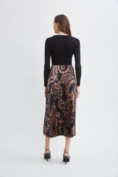 Our effortless Pleated Midi Dress has a distinct modern vibe. The crew neck viscose knit bodice combines with a graphic paisley print pleated skirt. Definitely poetry in motion! Mixed Media Printed Pleated Midi Dress with Ribbed Knit Mock Neck Bodice Bodice: 49% Spandex, 32% Viscose, 17% Nylon Skirt: 98% Polyester, 2% Spandex Model is 5'9" and wearing size S Measurements: 51 "L (shoulder to hem) Imported Dry Clean Style #: ETR44223 Nylon Skirt, Printed Pleated Skirt, Pleated Midi Dress, Modern Vibe, Pair Of Pants, Jacket Sale, Sweater Coats, Paisley Print, Dress Accessories