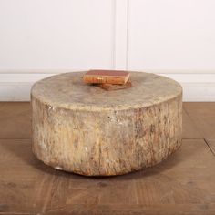 a wooden table with a book on it sitting on top of a hard wood floor