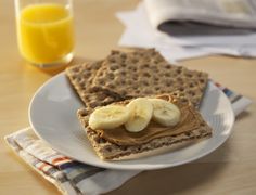 some waffles with peanut butter and bananas on them are sitting on a plate