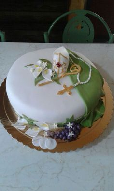 a white cake with green and gold decorations