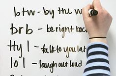 a person writing on a white board with black marker