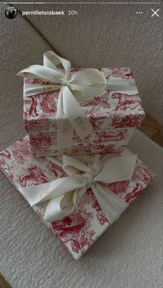 three wrapped presents sitting on top of each other