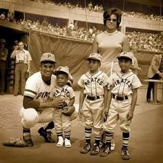 the baseball players are posing for a photo with their coach and two children in uniform