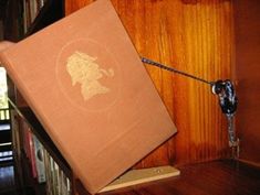 an open box sitting on top of a wooden shelf next to a lamp and bookshelf