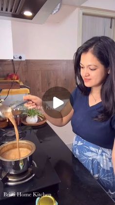 a woman is pouring something into a pot on the stove