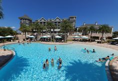 people are in the swimming pool at an apartment complex