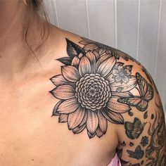 a woman with a flower tattoo on her shoulder