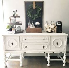 a white dresser with coffee and bar signs on it