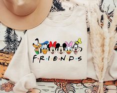 White Disney Cotton Sweatshirt, White Crew Neck Top For Disney Trips, White Disney Crew Neck Sweatshirt, Disney White Top With Letter Print, White Letter Print Sweatshirt For Disney Fan Events, White Letter Print Sweatshirt For Disney Events, White Disney Long Sleeve T-shirt, White Long Sleeve Disney T-shirt, White Tops With Letter Print For Disney Trips