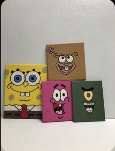 four square paintings with cartoon characters painted on them