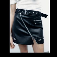 High-Waist Mini Skirt With A Belt In The Same Fabric With Metal Buckle, Zip Appliqus. Edgy Belted Spring Bottoms, Edgy Belted Bottoms For Spring, Spring Club Mini Skirt With Zipper Closure, Black Belted Bottoms, Punk Style, Punk Style Black Belted Bottoms, Black Punk Style Belted Bottoms, Punk Black Belted Bottoms, Punk Style Bottoms With Belt For Spring, Punk Style Skirt With Zipper For Night Out