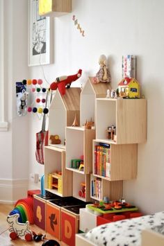 a child's room with toys and bookshelves