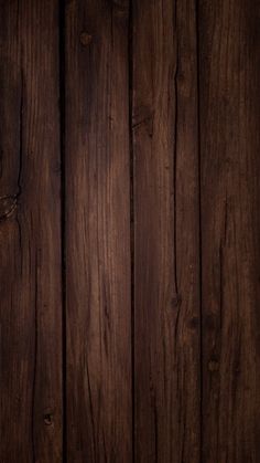 an old wooden wall with dark wood grains