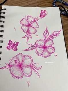 a drawing of flowers and butterflies on a notebook