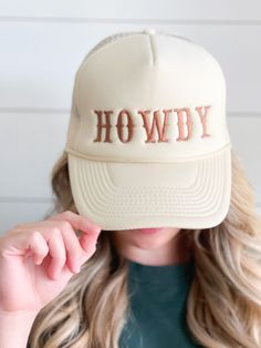 Hat is trucker style featuring Howdy embroidery. Perfect for a weekend in Nashville or for country concerts.  Hat Details: 100% Polyester foam front, mesh back Structured, five-panel, mid-profile 3 ½" crown Pre-curved visor with braid detailing Adjustable double snapback closure