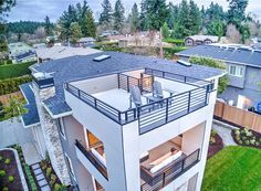 an aerial view of a two story house with lots of windows and balconies