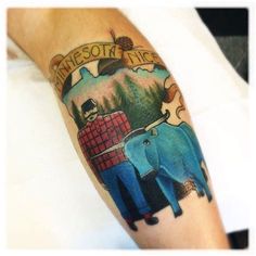 a person with a tattoo on their arm that has an elephant and bear in it