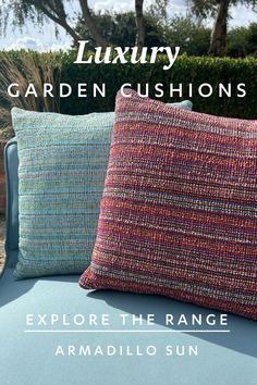 Luxury garden cushions. Explore the range from Armadillo Sun. Image of two textured woven cushions, one in shades of blue and one in shades of red.